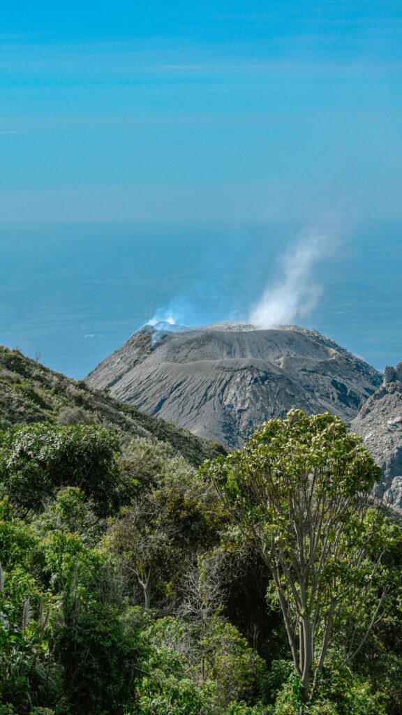 Active volcano landscape in Guatemala surrounded by lush coffee-growing mountains