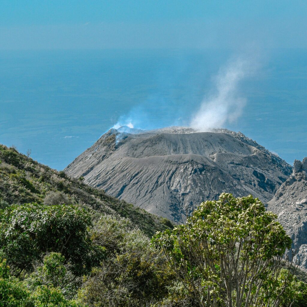 Active volcano landscape in Guatemala surrounded by lush coffee-growing mountains